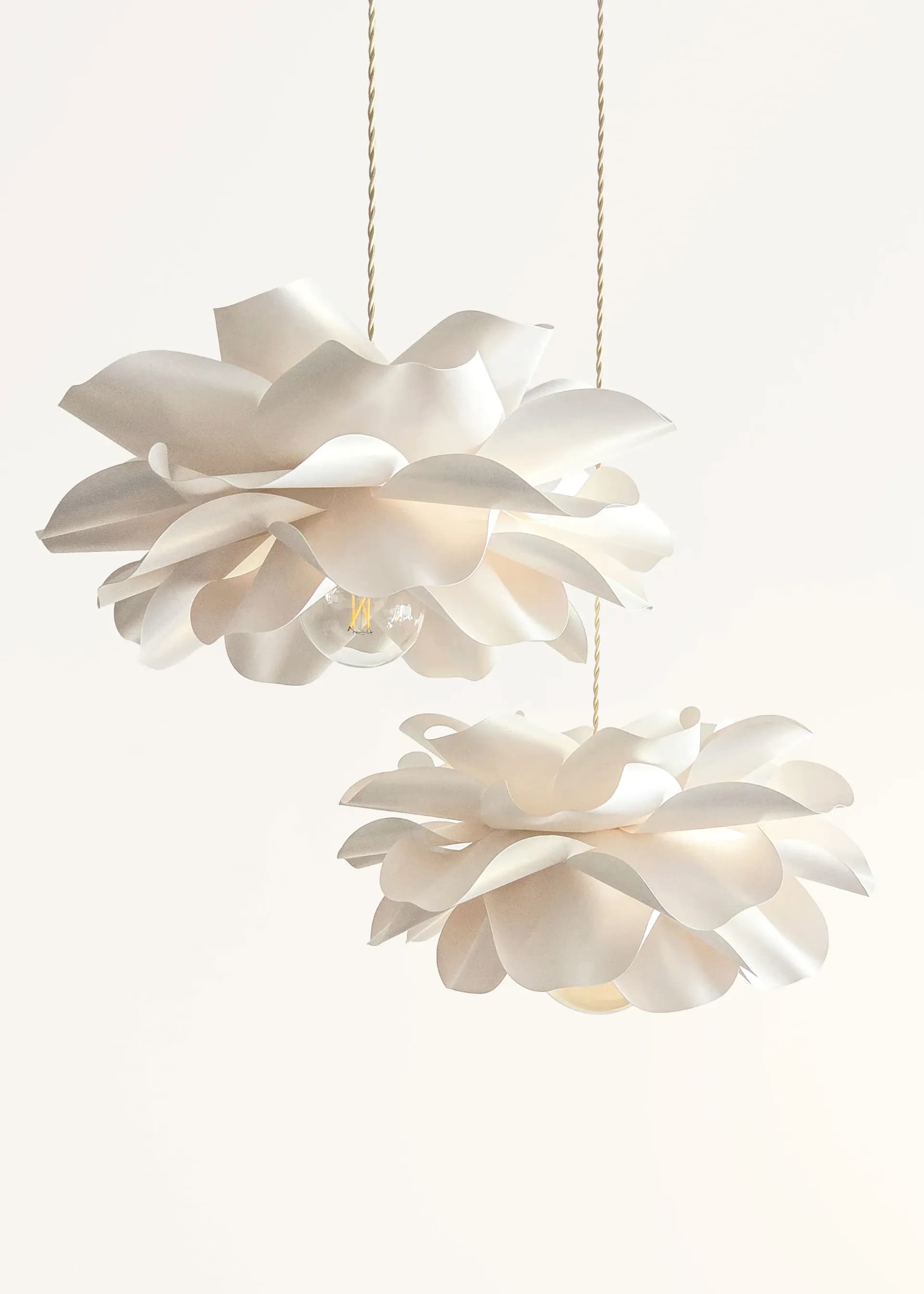 Set of two ivory flower pendant lights at different heights
